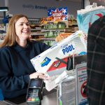 Quality Save employee serving a customer