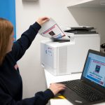 Quality save employee using a HP printer and Lenovo laptop provided by Midshire