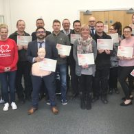Group shot of Midshire staff with British Heart Foundation CPR training certificates