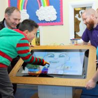 Child using the interactive touch table from midshire